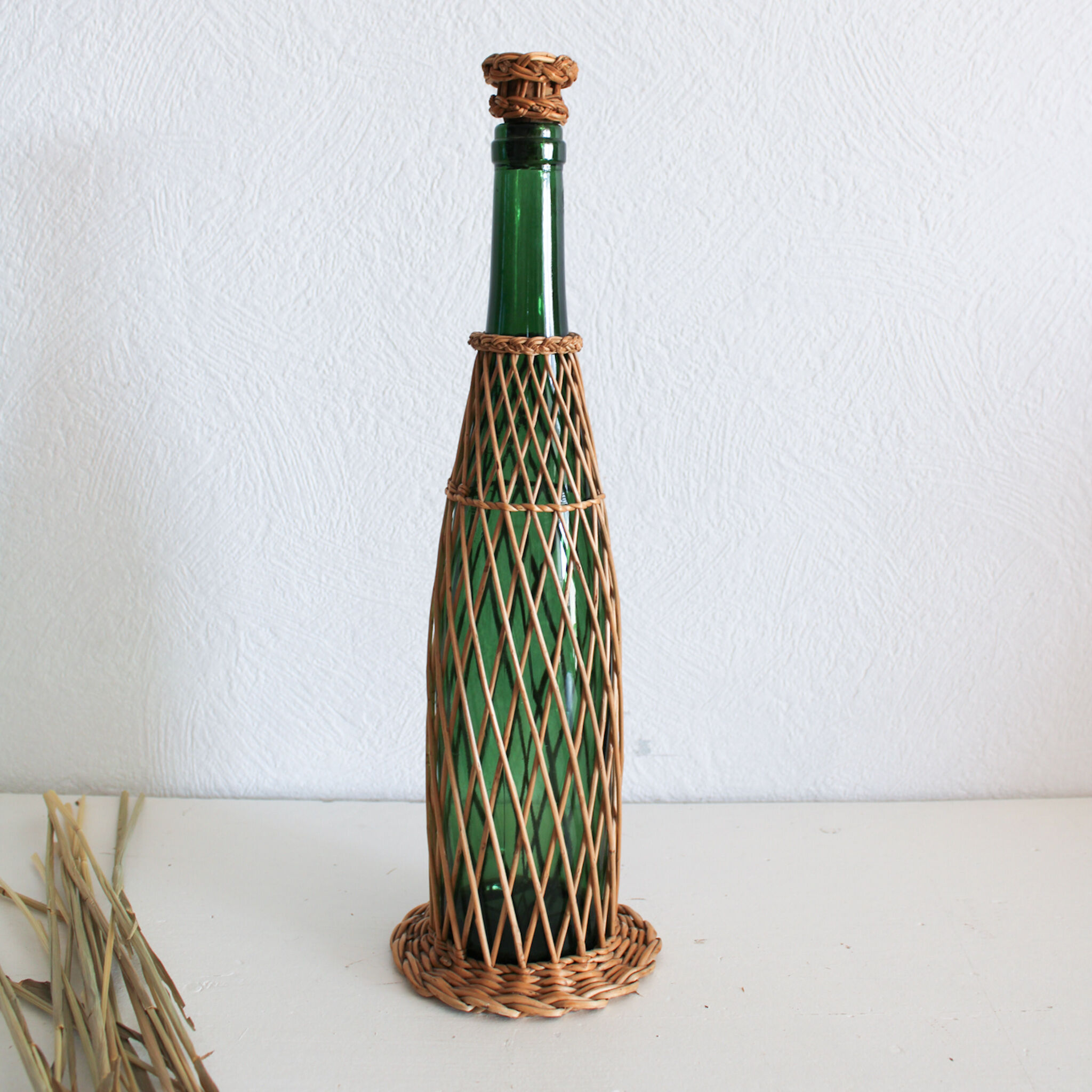 Glass and wicker bottle