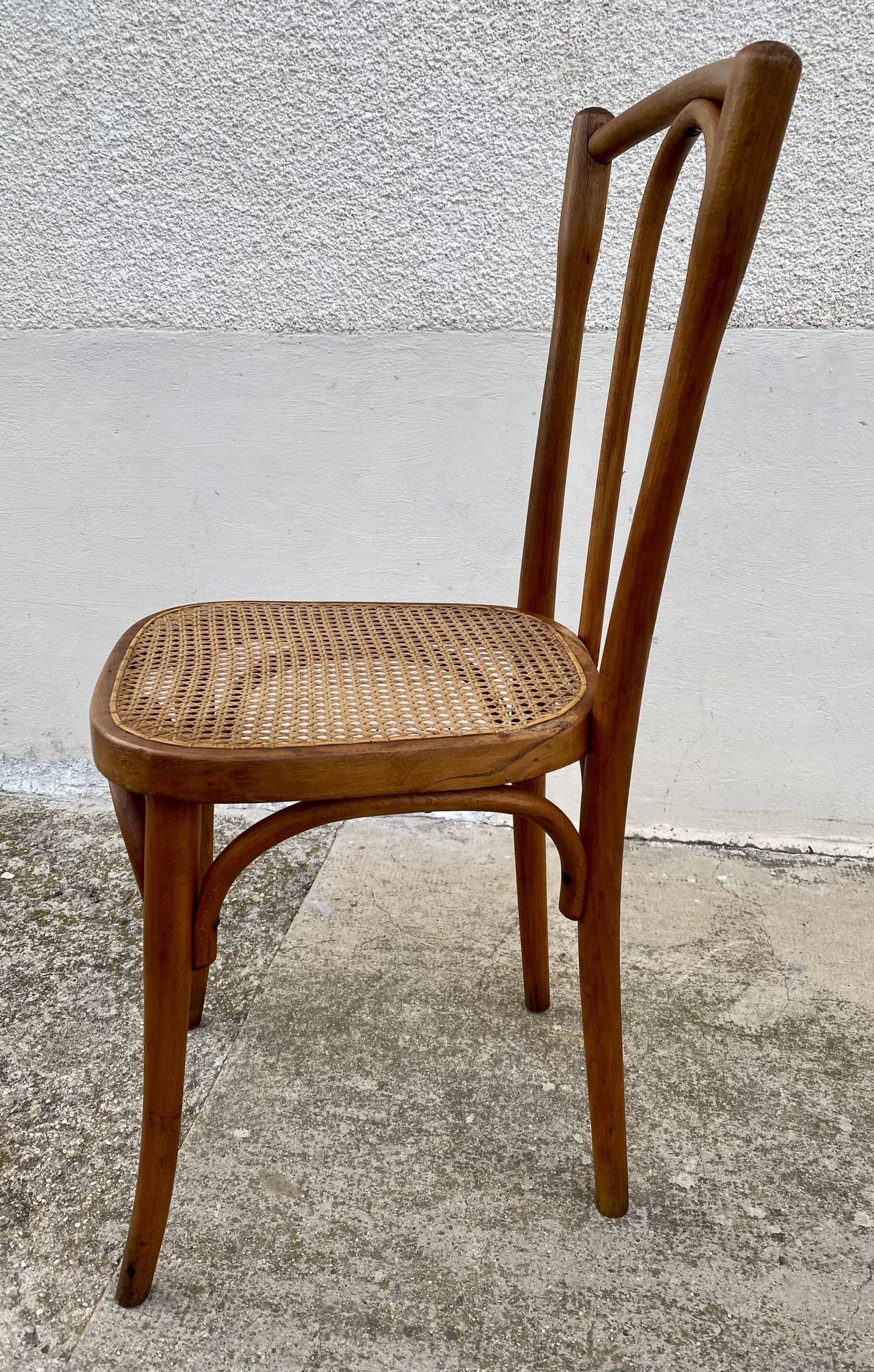 19th-century bistro chair, signed, with caned seat.