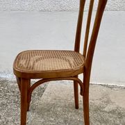 19th-century bistro chair, signed, with caned seat.