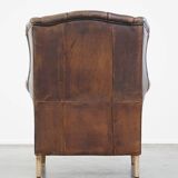 Wing chair made of sheepskin and neatly finished with black piping