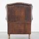 Wing chair made of sheepskin and neatly finished with black piping