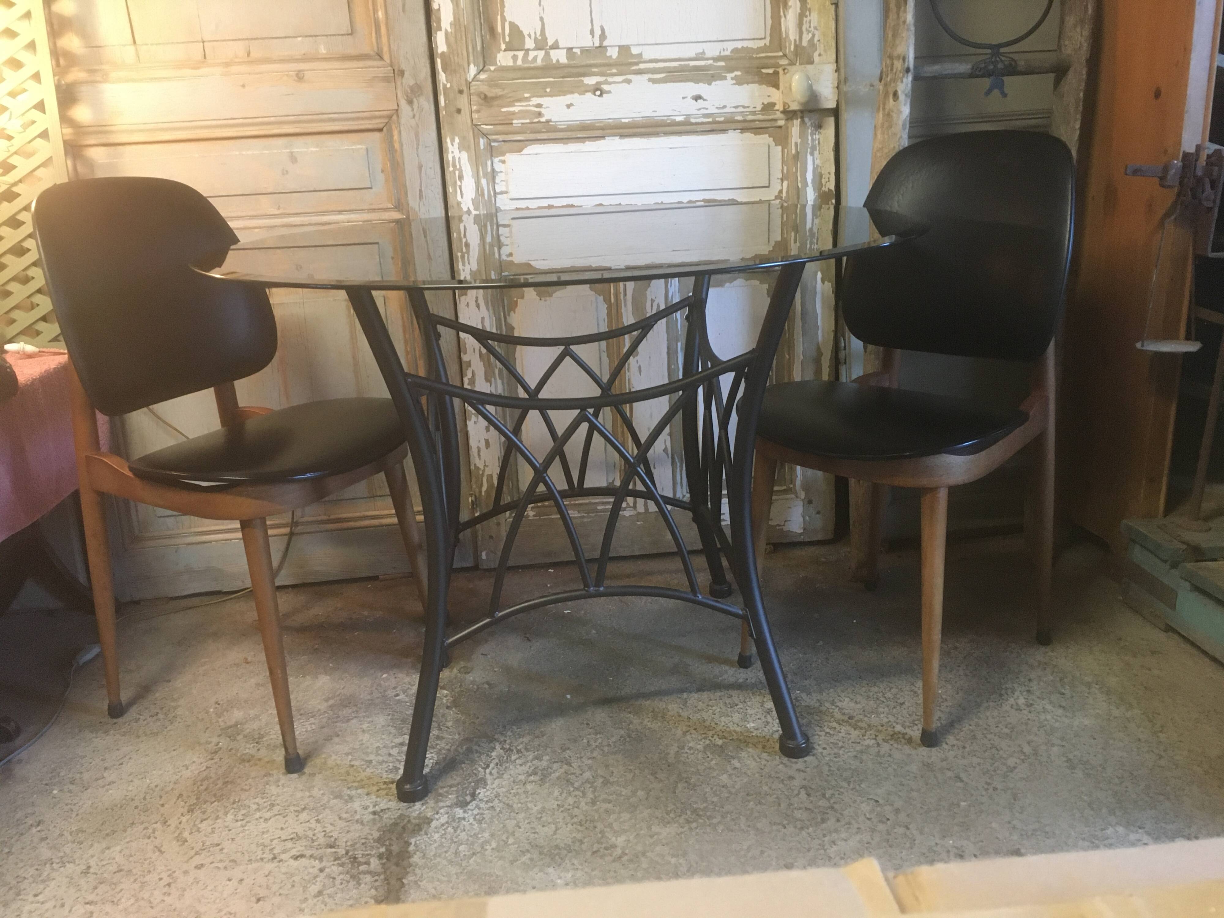 Round table with metal legs and smoked glass