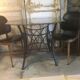 Round table with metal legs and smoked glass.