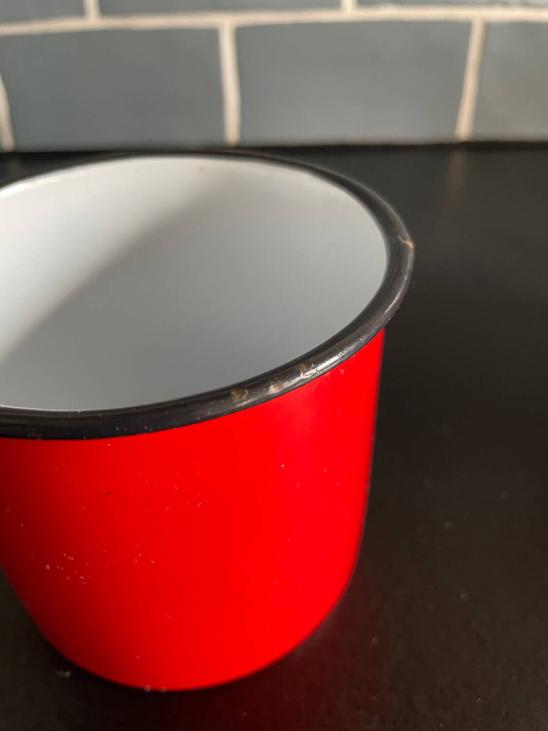 Red enameled sheet metal mug