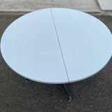 White dining table with a central pedestal, extendable, from the 1970s.