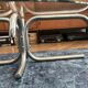 Oval glass coffee table with chrome legs, vintage 70s design.