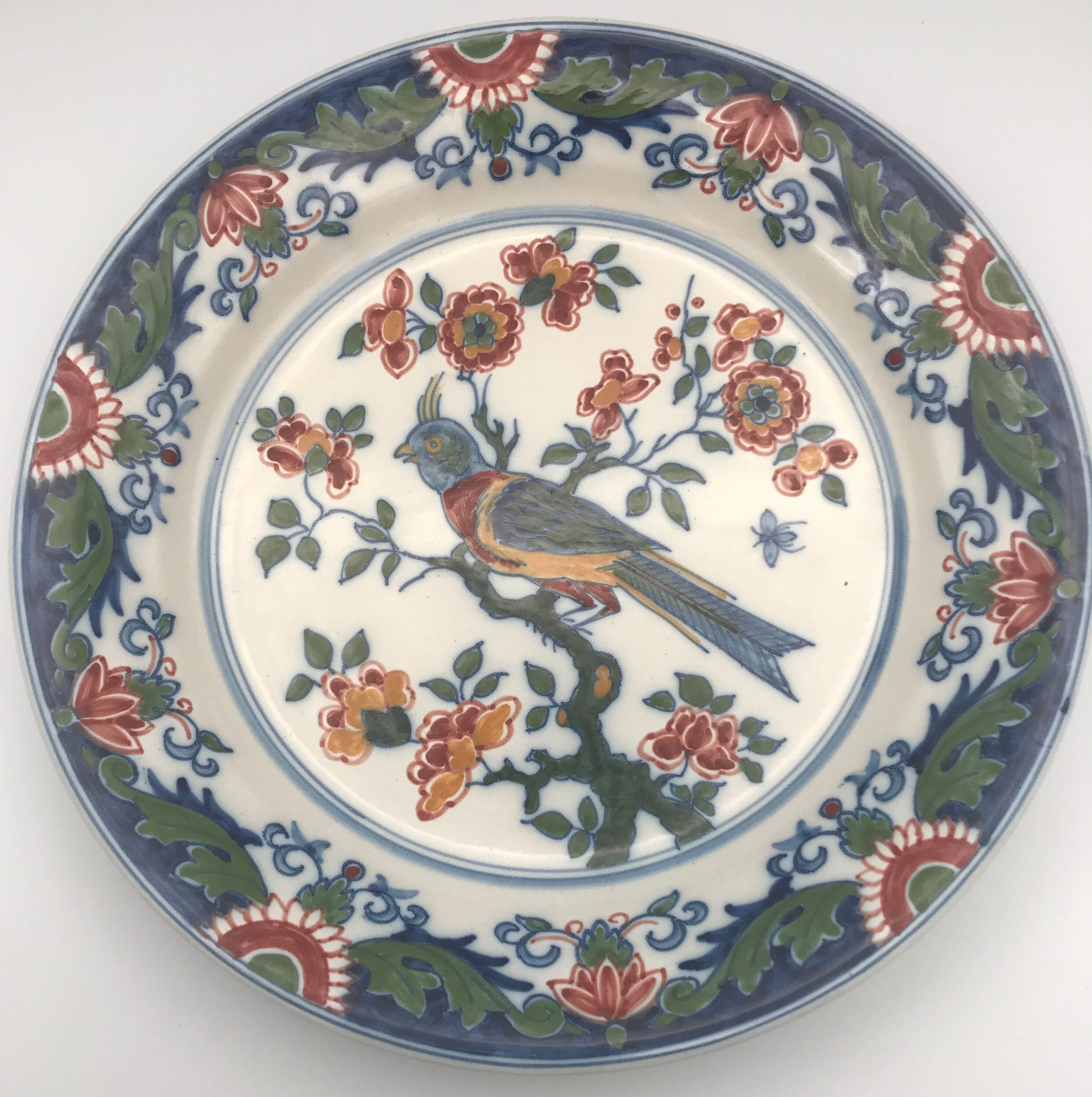 Wall plate in earthenware decorated with painting of flowers and bird 28 cm