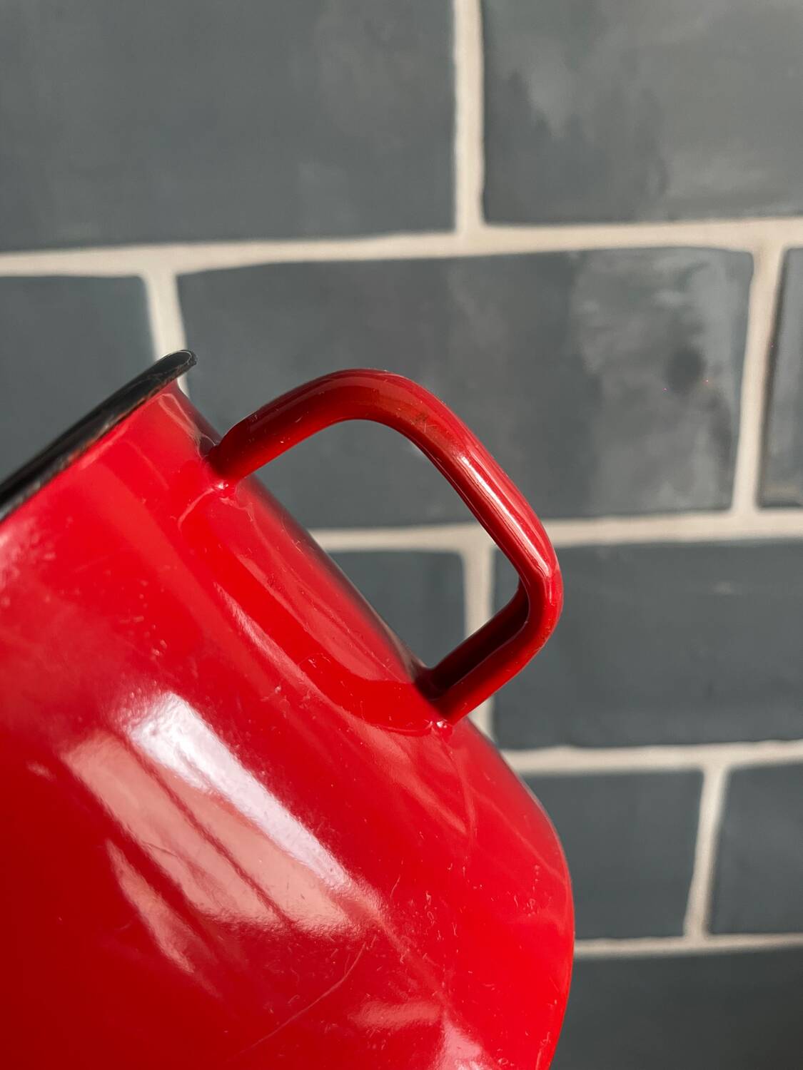 Red enameled sheet metal mug
