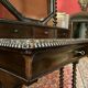 Antique English mahogany dressing table with carved details, black marble, and mirror.