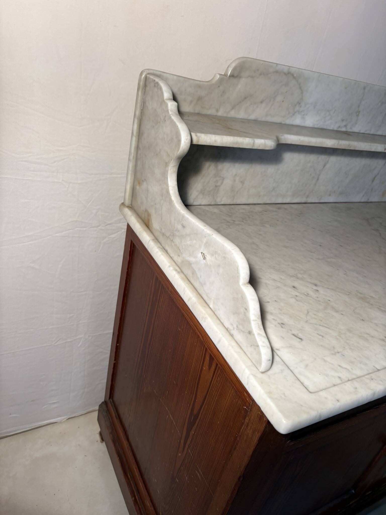 Antique wood and marble kitchen sideboard with carved backsplash