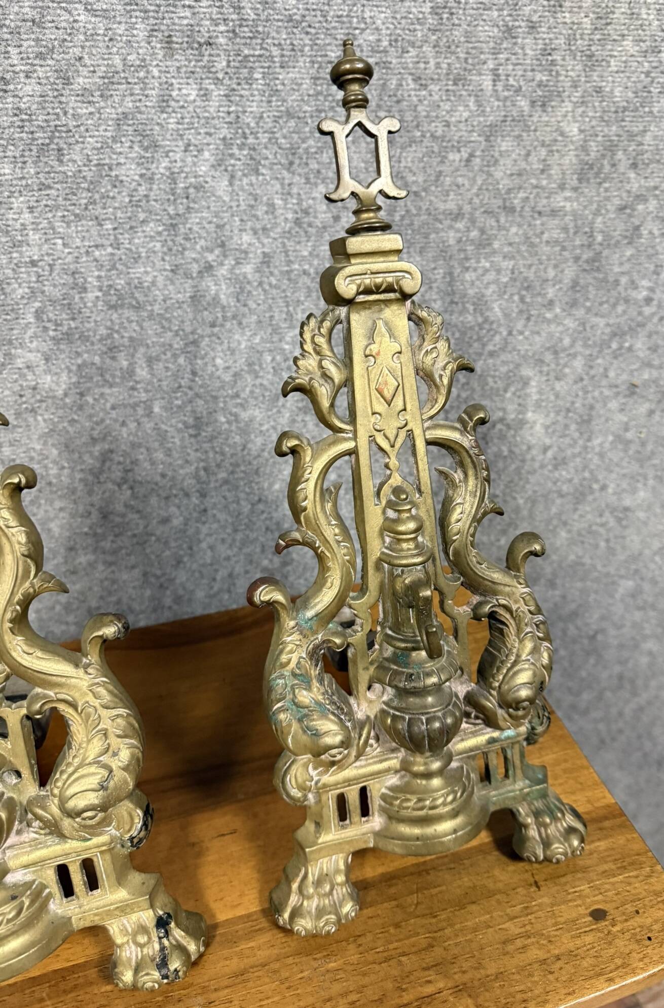 pair of Empire period dolphin firedogs in gilded bronze