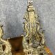 pair of Empire period dolphin firedogs in gilded bronze