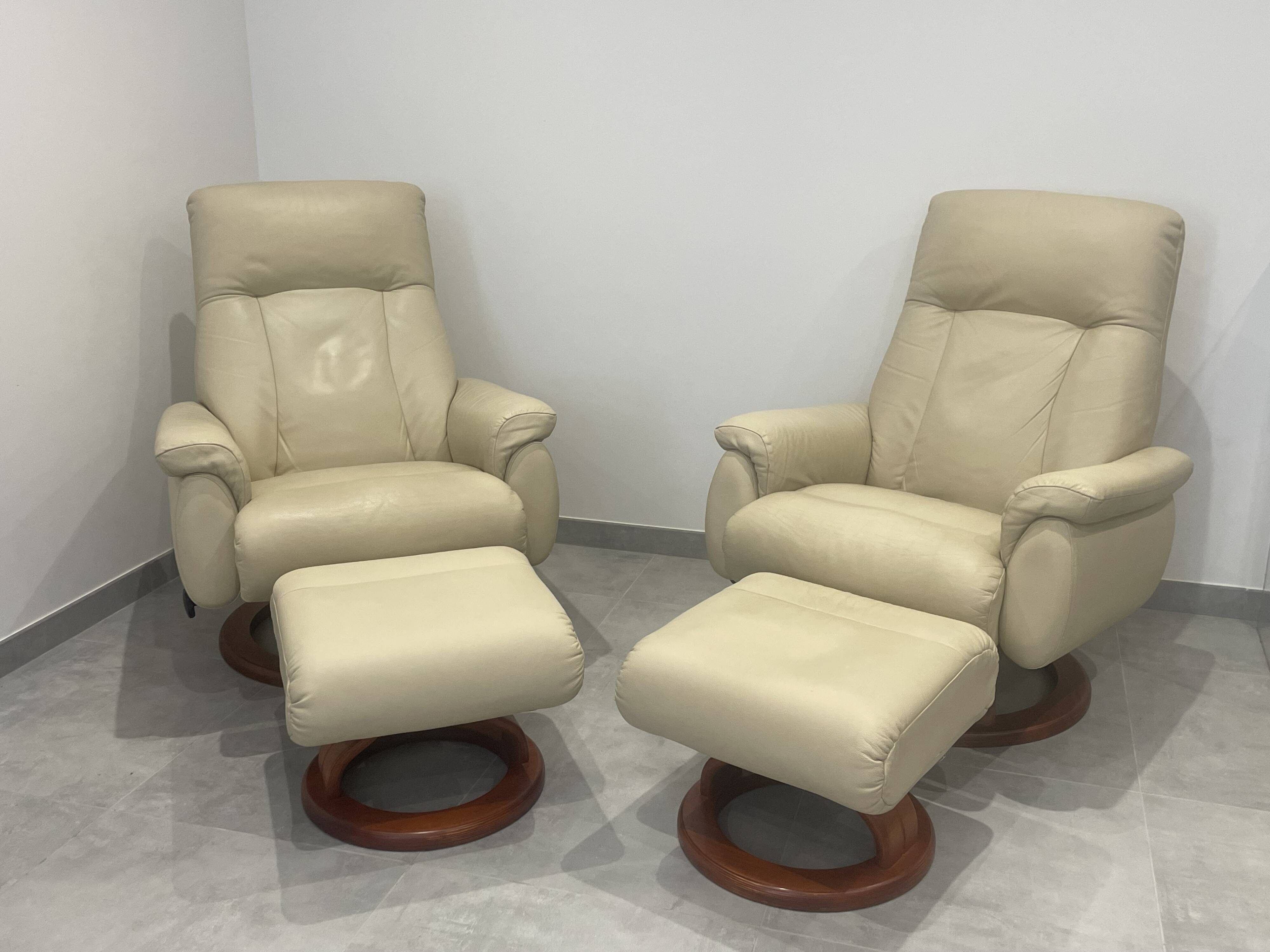 Pair of vintage leather armchairs with ottoman