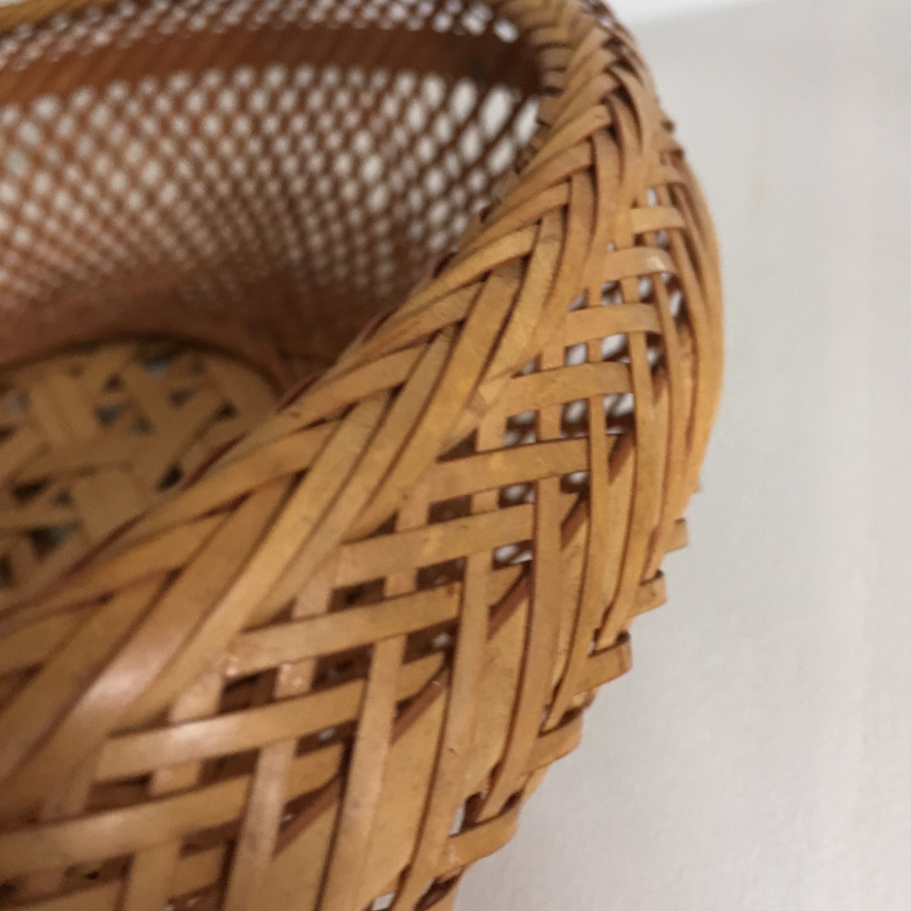 Braces of wood and woven rattan oval basket