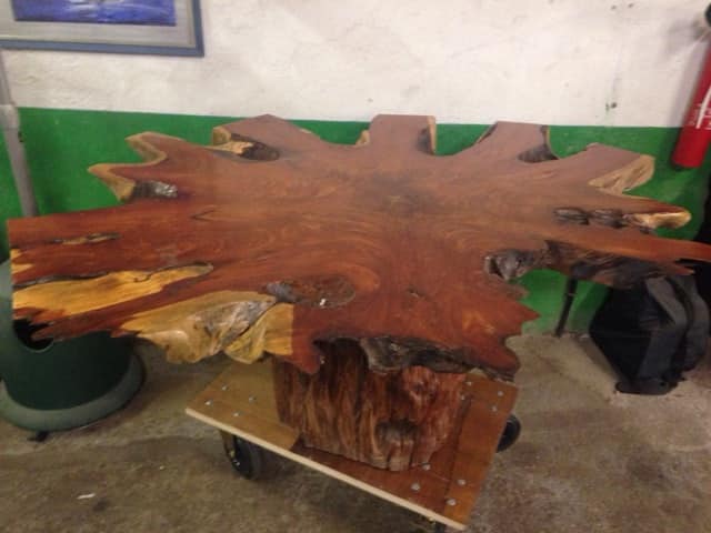Round table carved from a wooden slice of PADOUK
