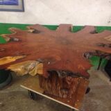 Round table carved from a wooden slice of PADOUK