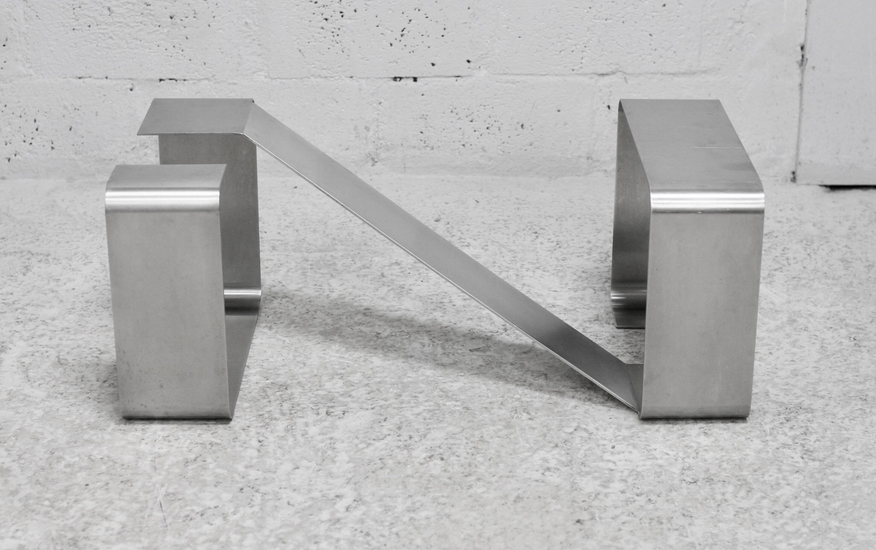 Coffee table with "kinetic" steel base and glass slab. Circa 1970.
