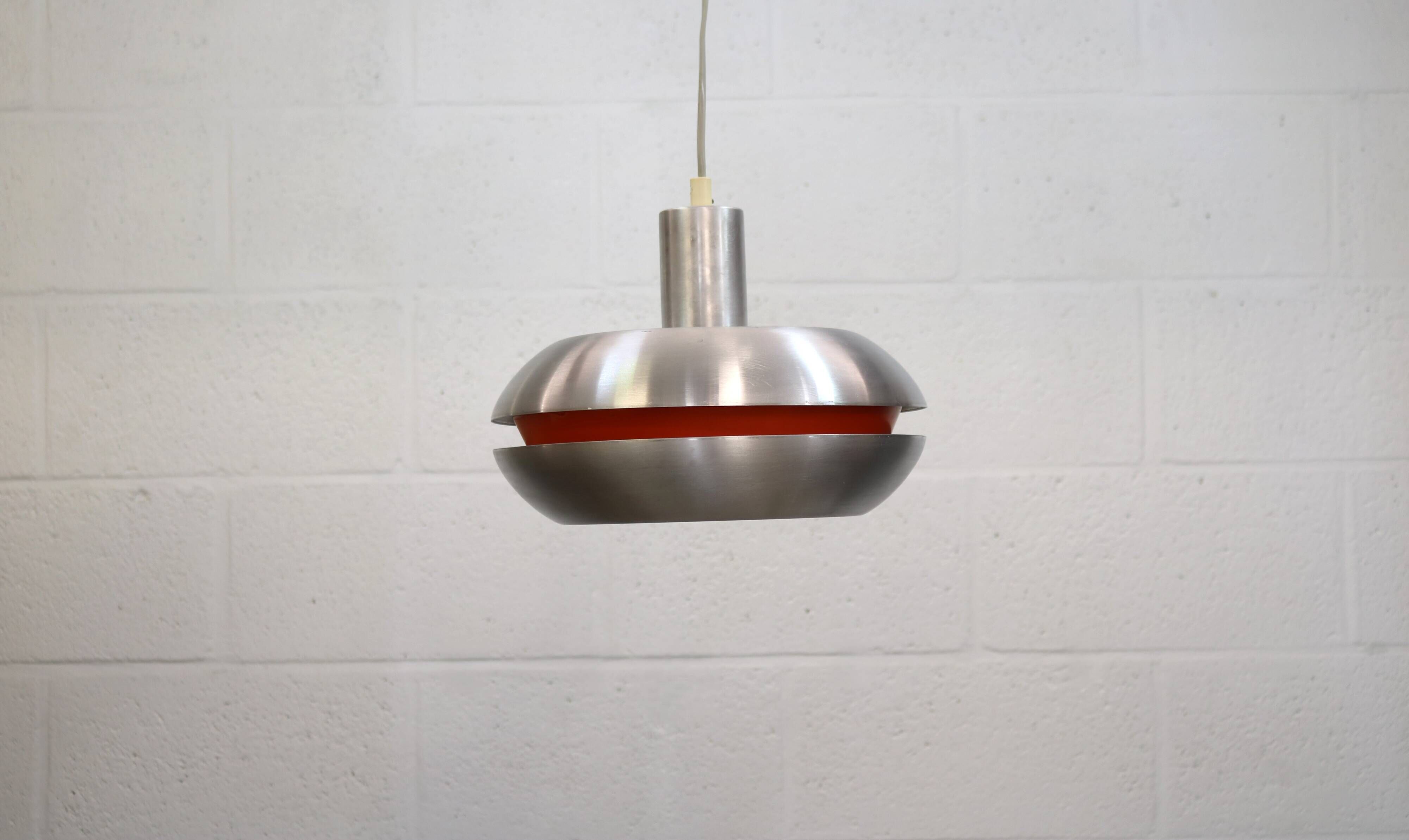 Old Danish space age design lamp in alu and orange inside.