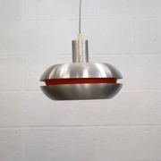 Ancienne lampe de design danois de l'ère spatiale en aluminium avec intérieur orange.