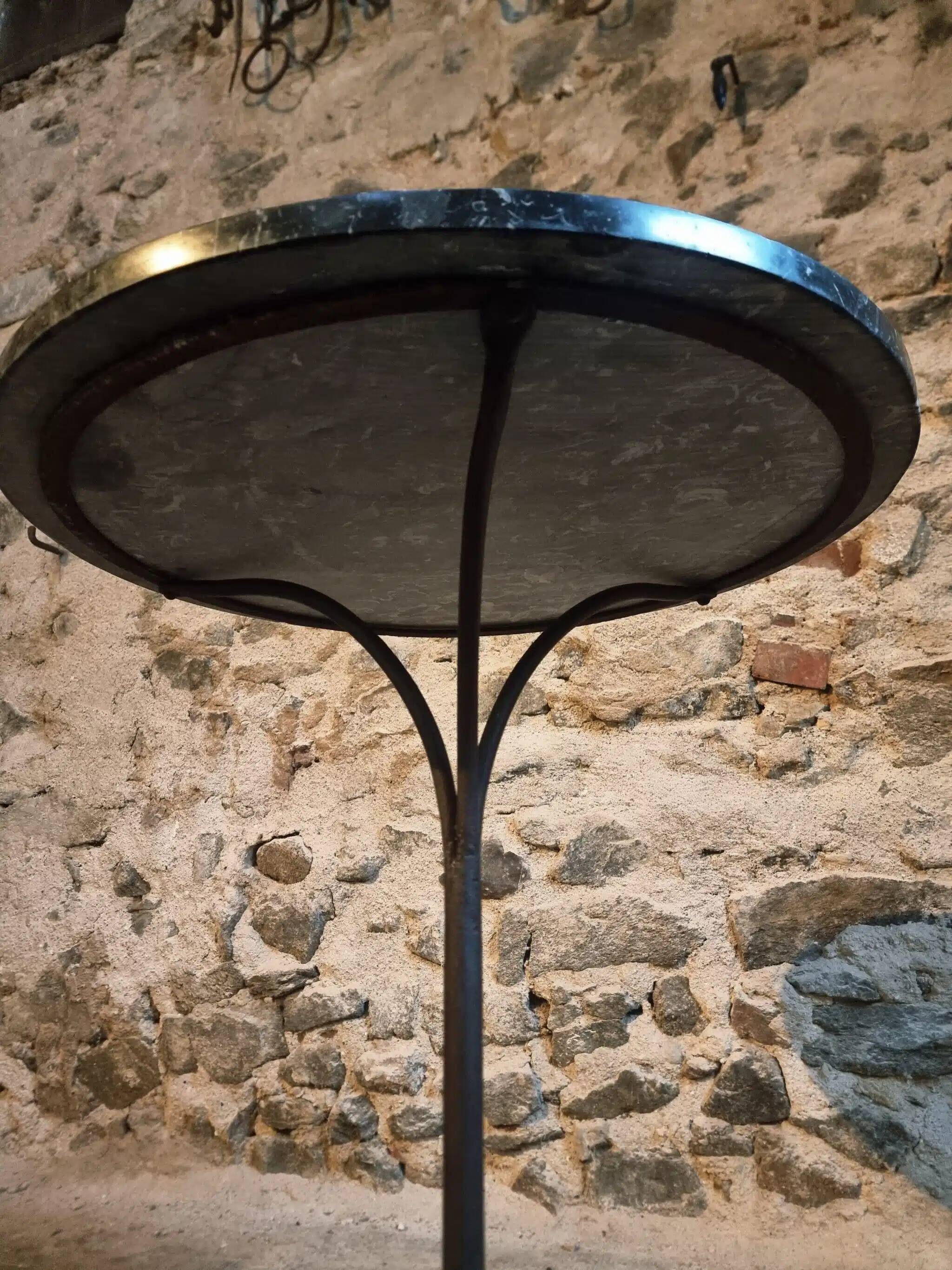 Old French bistro table with a marble top and a cast iron base.