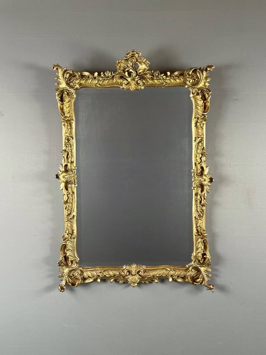 Large gilded wooden mirror in Louis XV style, 19th century.