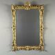 Large gilded wooden mirror in Louis XV style, 19th century.
