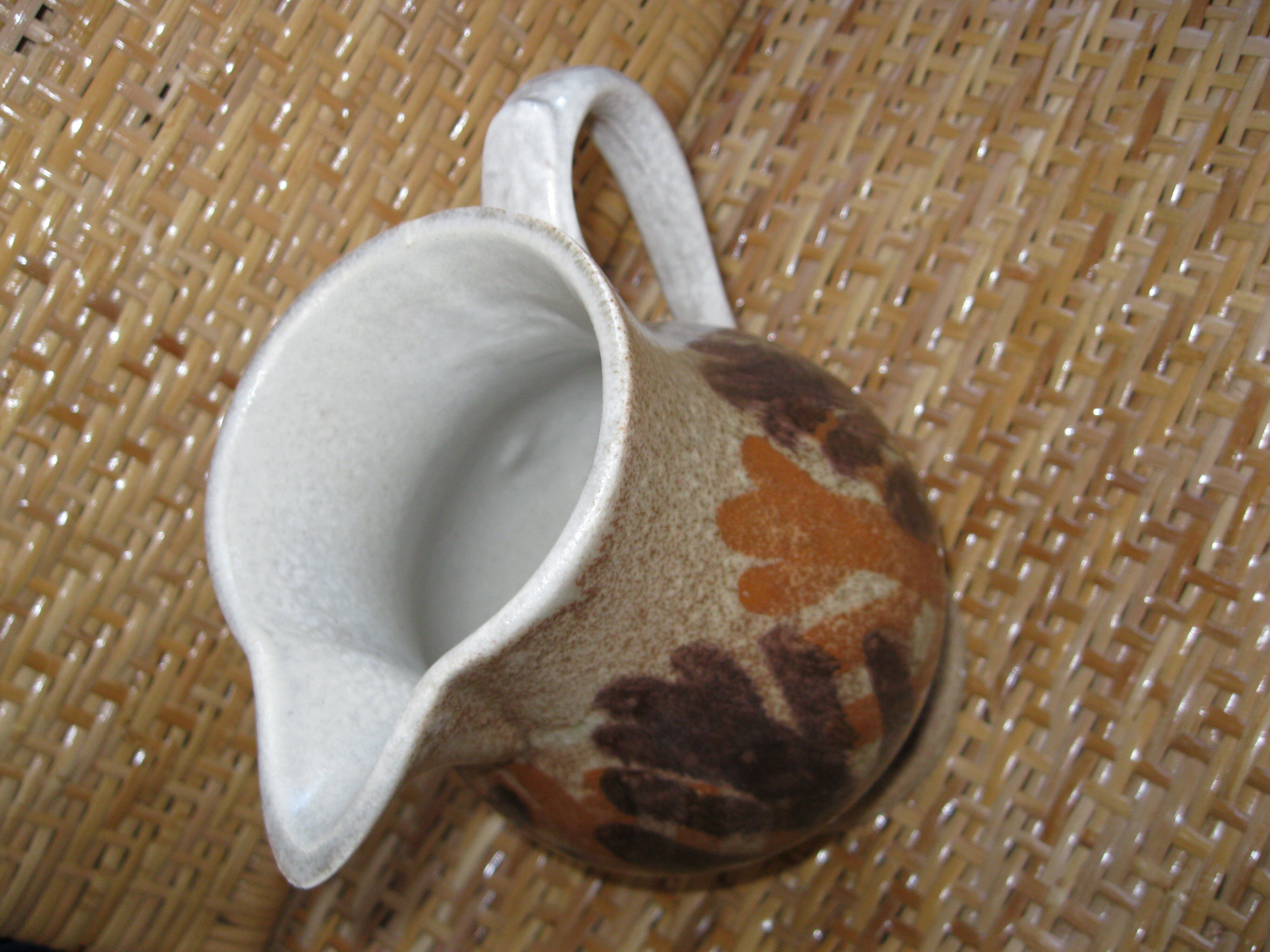 Glazed stoneware jug with hand decoration