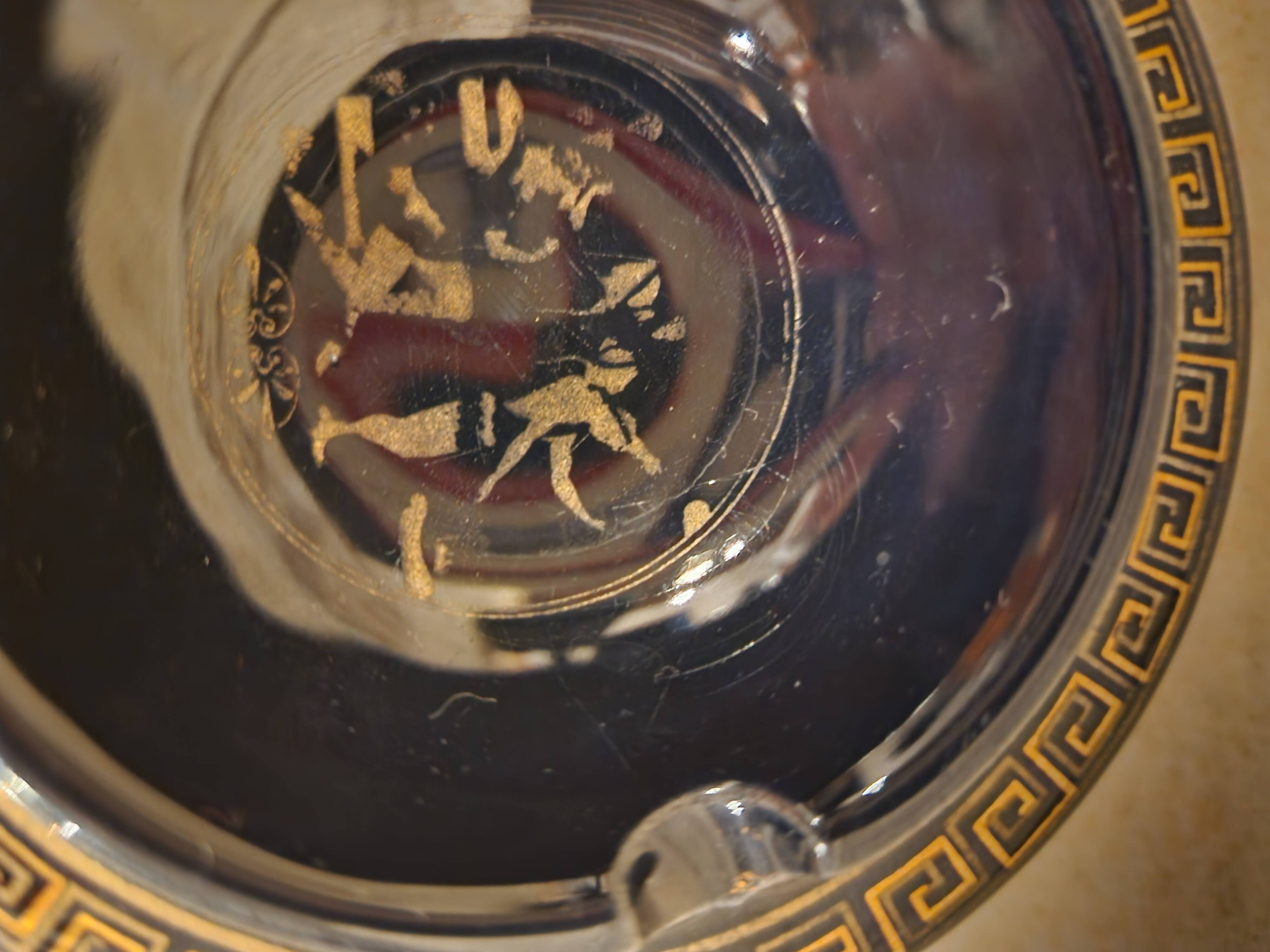 Small vintage ashtray in black ceramic with gold decoration in Greek style.