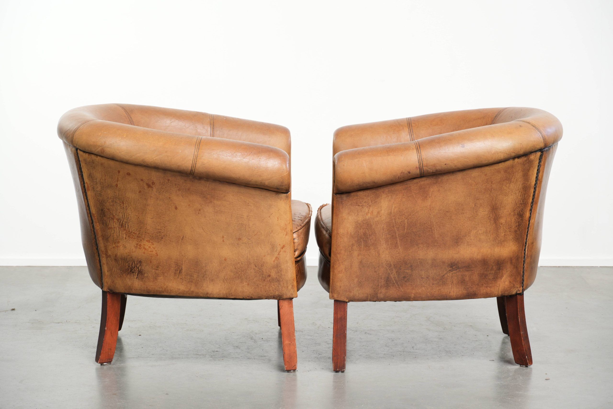 Set of two vintage sheepskin club armchairs with a beautiful light colour