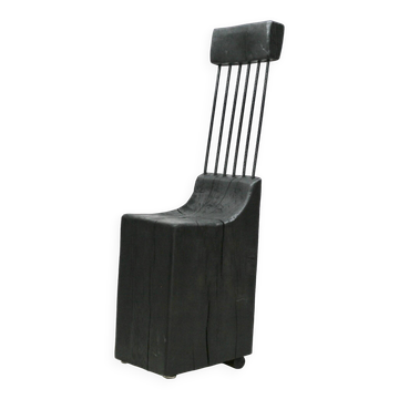 Brutalist chair, black-stained raw wood, steel. Work from the 1970s