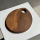 Small circular teak monoxyle cutting board with handle 22 x 13.