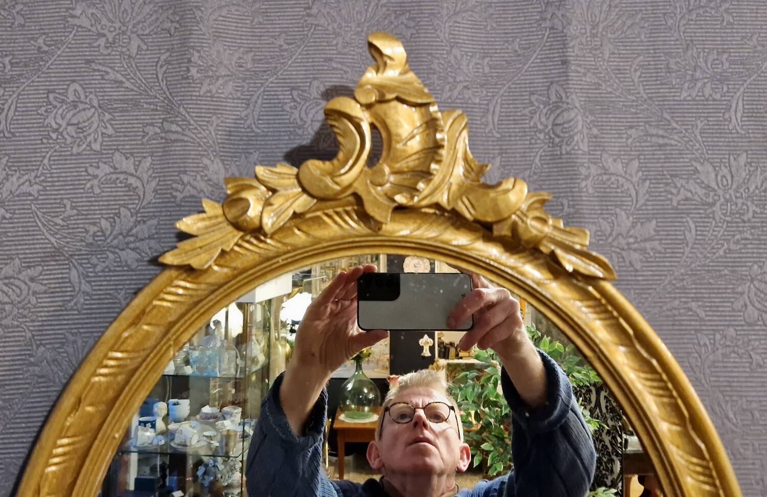 Golden oval mirror