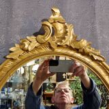 Golden oval mirror