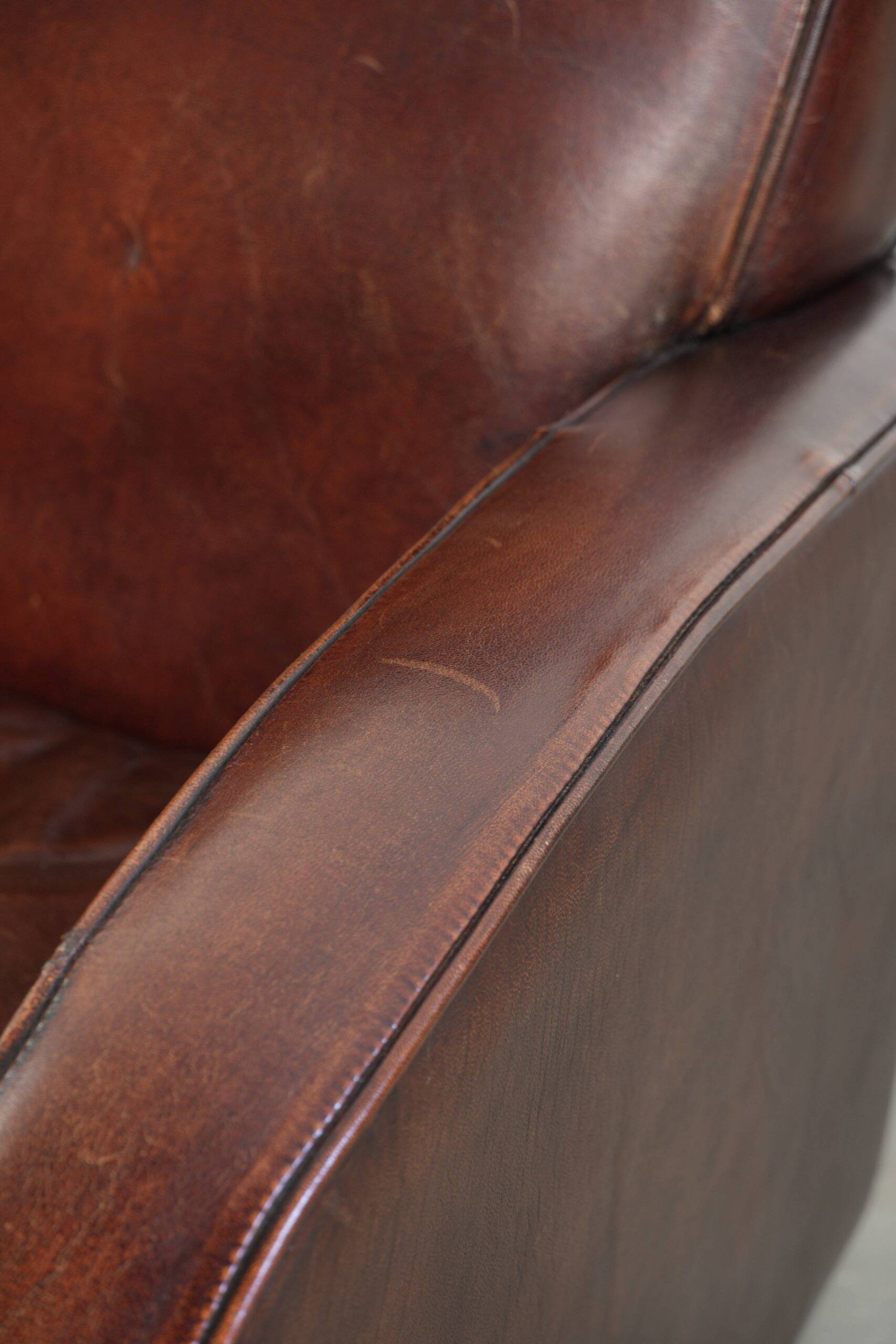 Dark cognac-coloured set of 2 sheepskin armchairs with a sleek design