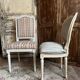 Pair of Louis XVI style chairs in painted wood and satin, classic elegance.