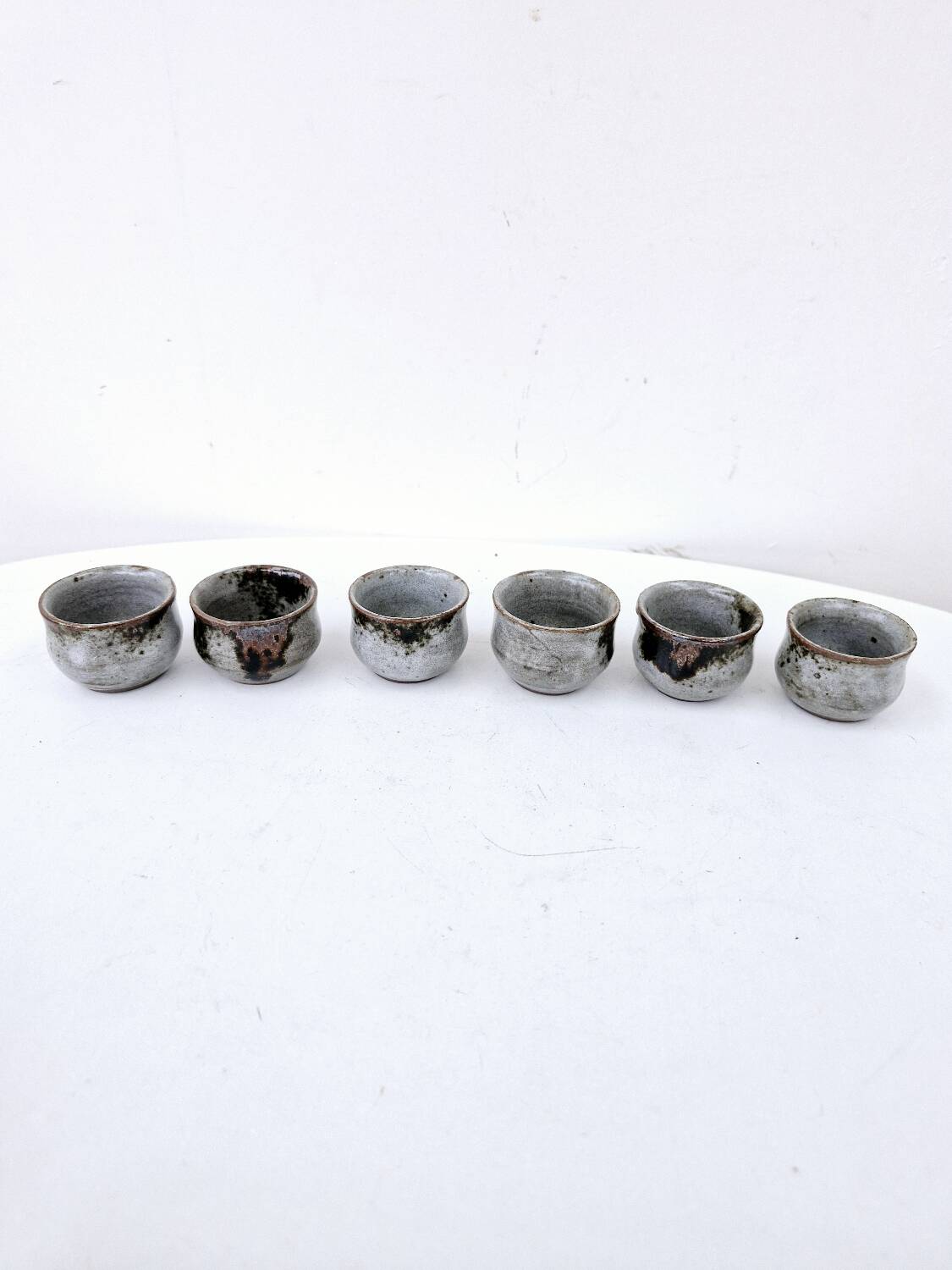 Vintage enameled stoneware service with 6 small bowls and a sugar bowl or sauce bowl