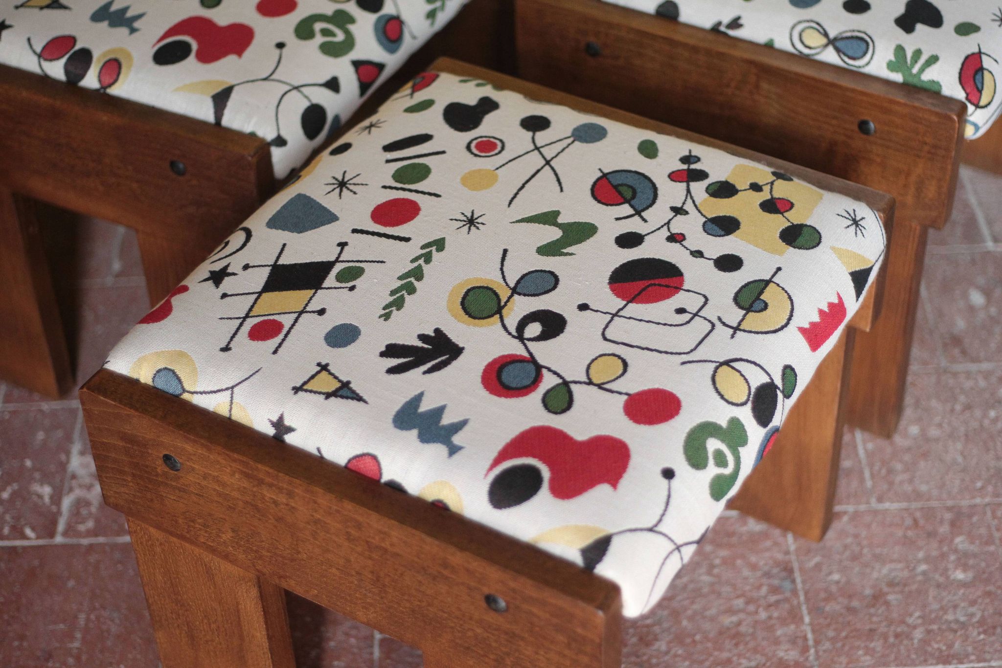 Set of 3 beech wood stools with fabric upholstery in the style of Miro.
