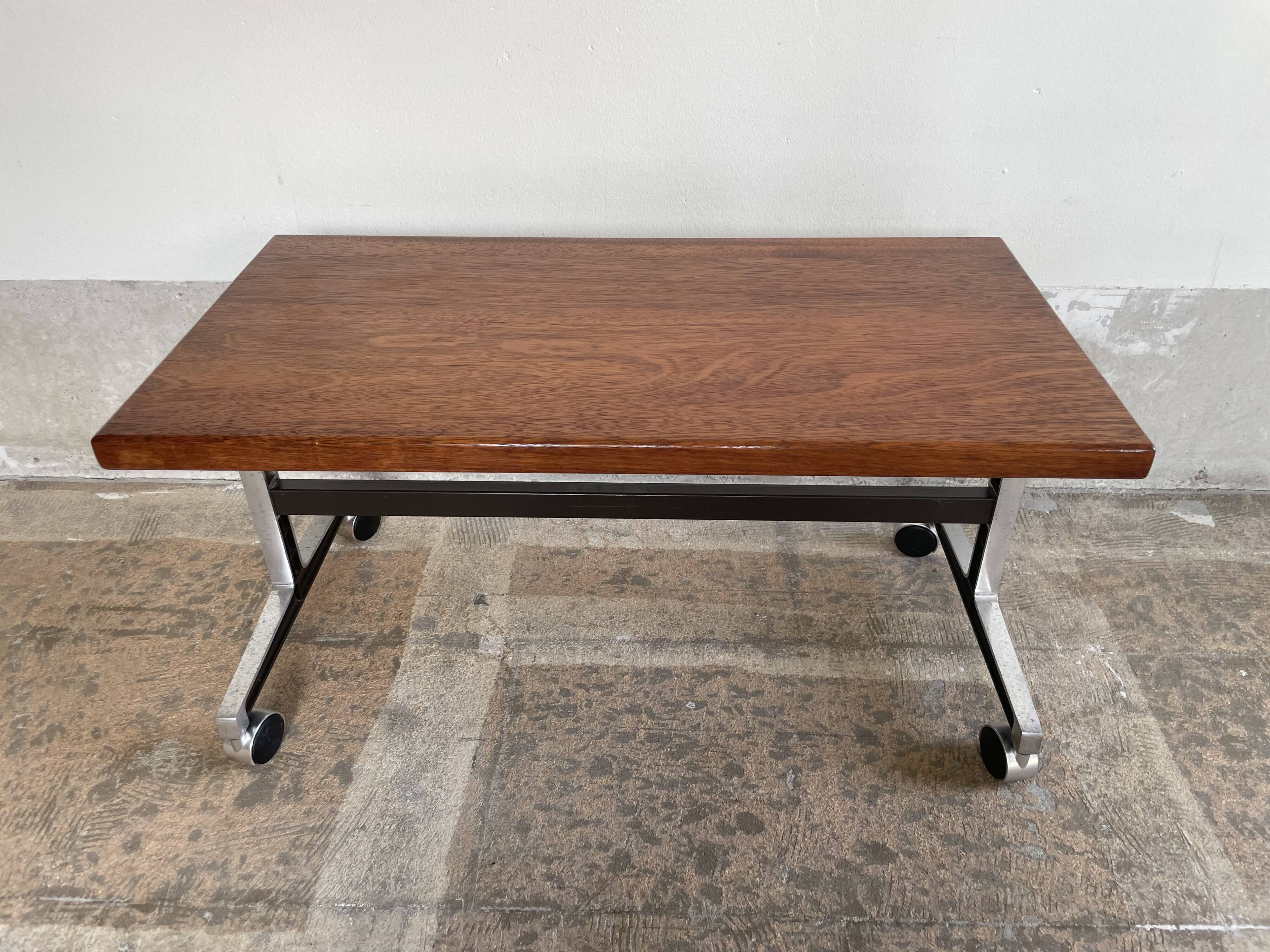 Wooden side table with chrome frame on wheels