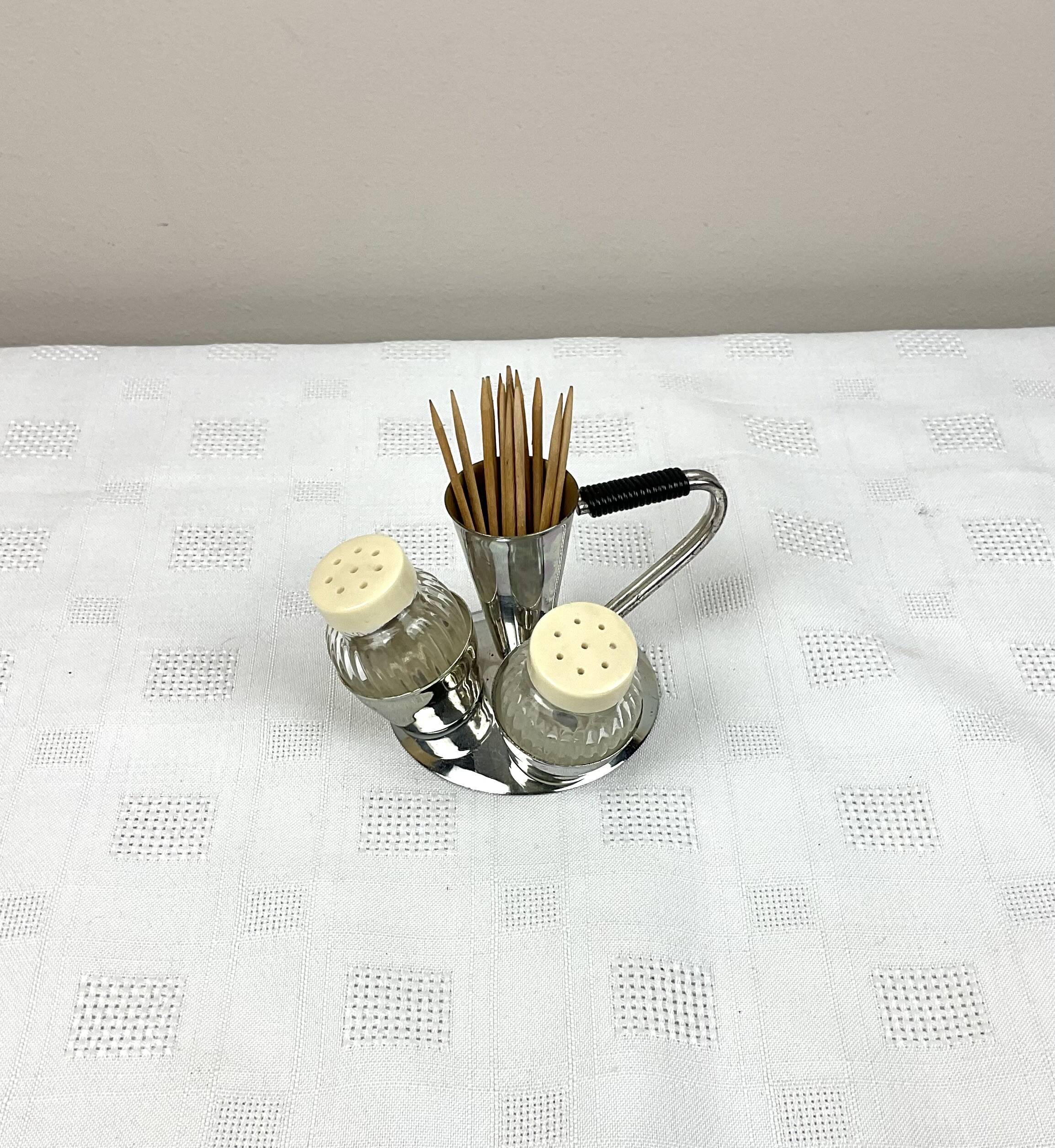 Vintage salt and pepper shakers and their chrome metal support