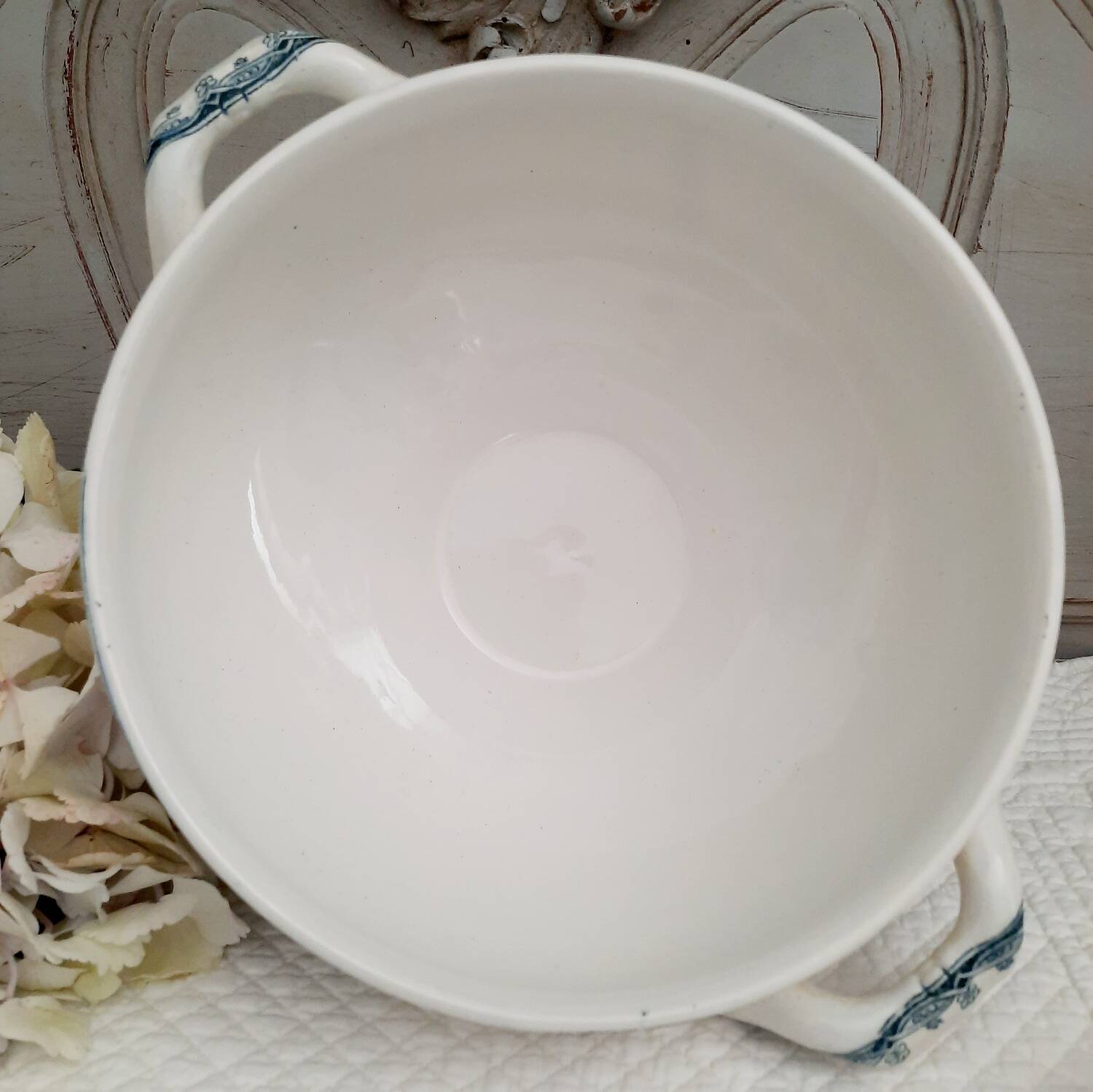Old mismatched hollow plates in iron earth earthenware accompanied by a soup tureen
