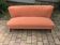 Coral mid-century cocktail canapé in fabric, solid beech legs — 1950