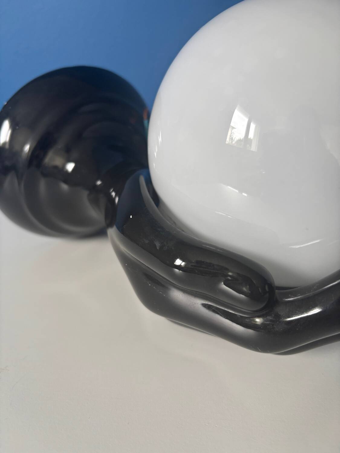 Vintage wall sconce with black hand and white opaline glass globe, 1970s L