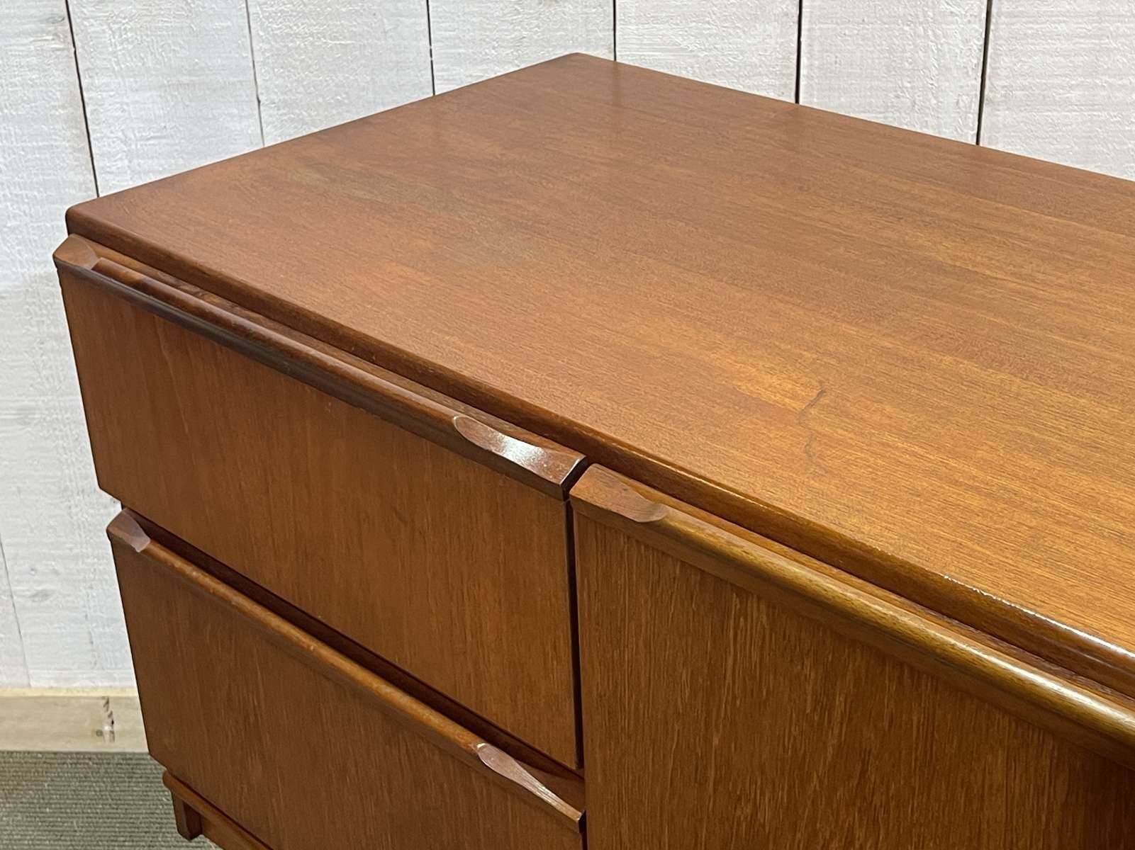 1970s English enfilade in teak with splayed legs.
