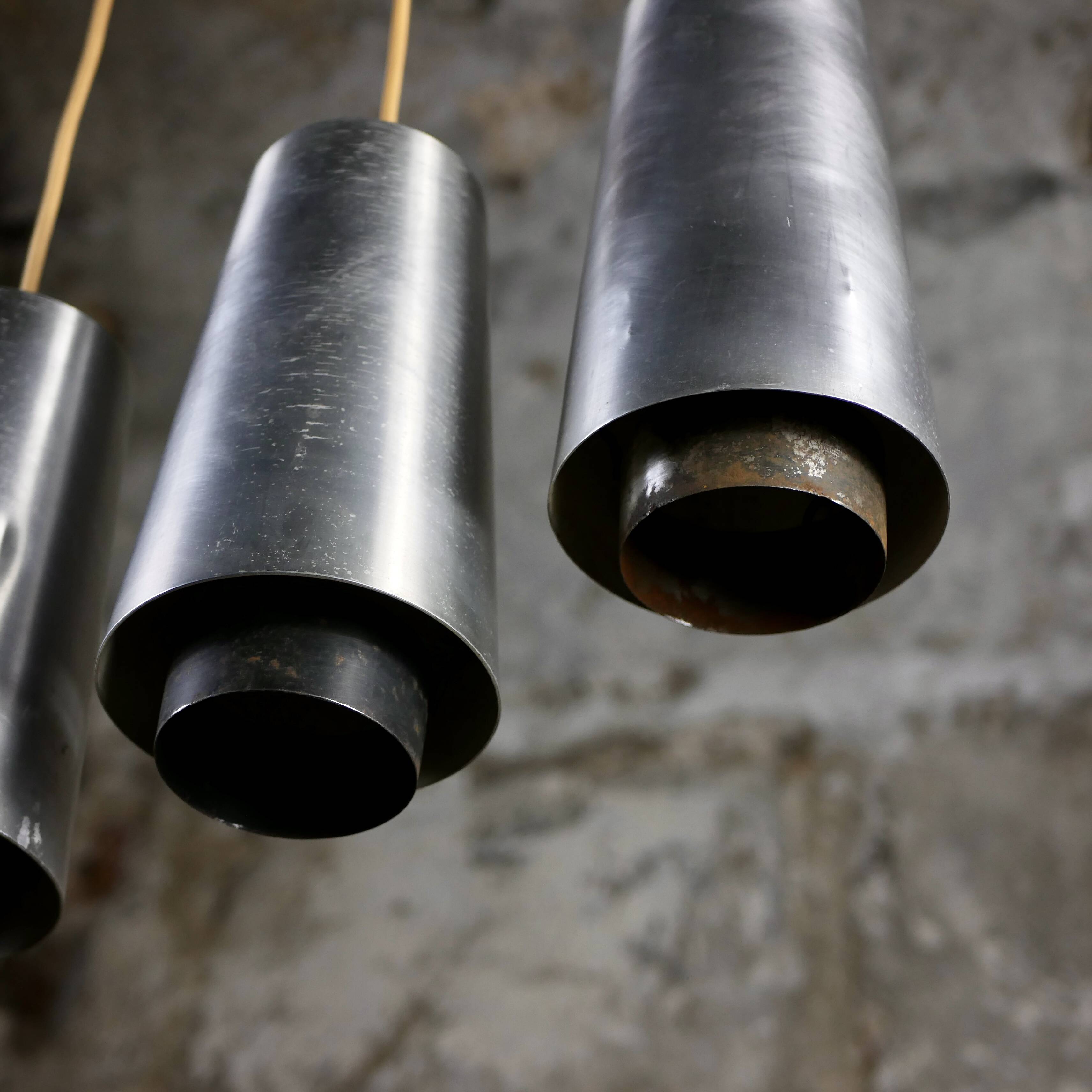 Trio of Raak steel pendant lights, 1960s