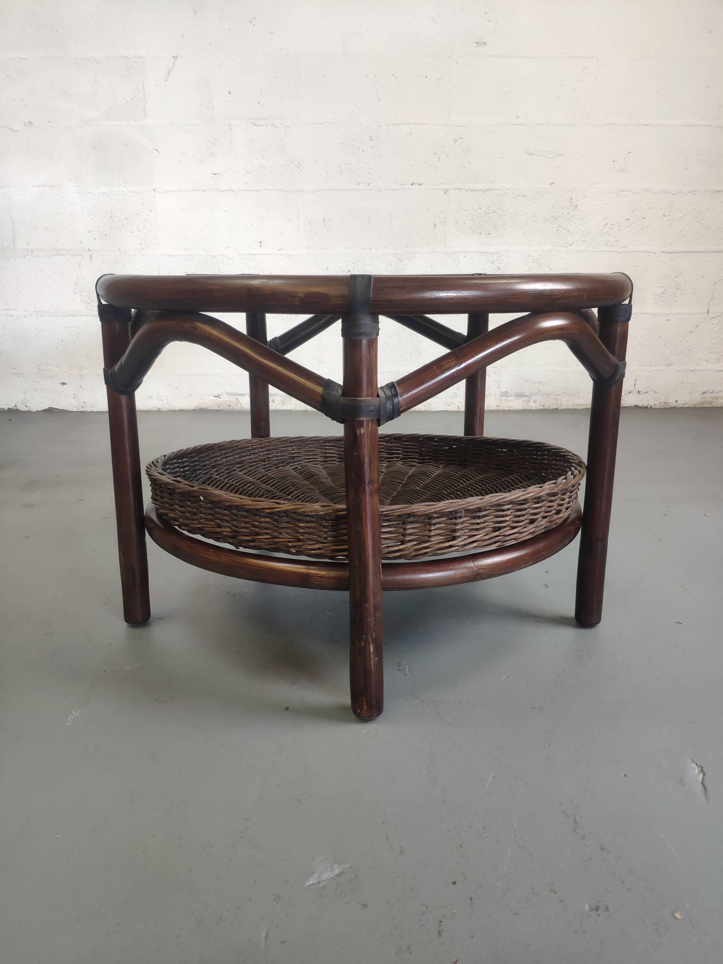 Vintage rattan coffee table with smoked glass top and rattan basket shelf