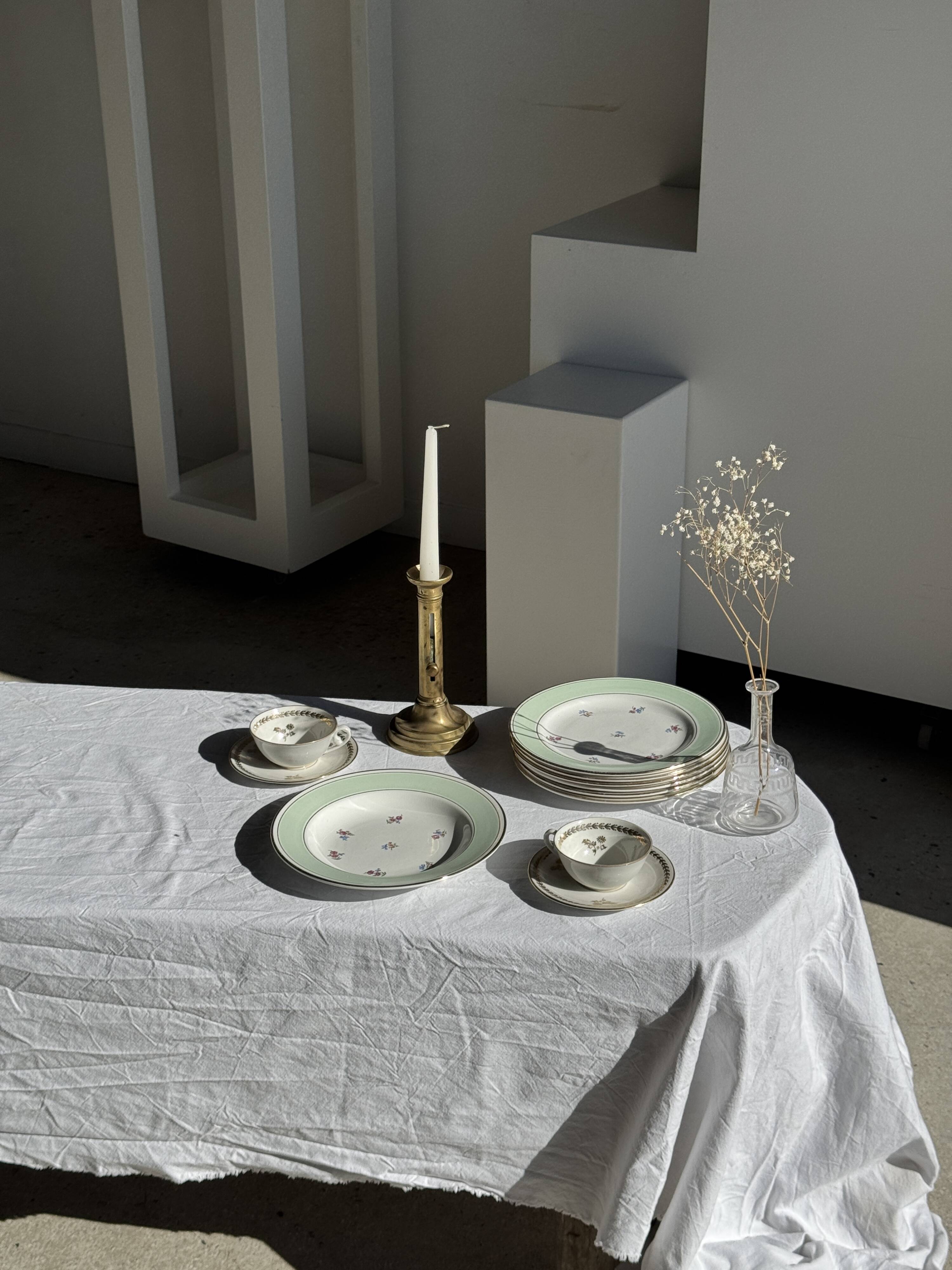 Set of 9 vintage turquoise deep plates with gold trim and pink flowers.