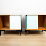 A pair of vintage mid-century bedside tables with glass sliding doors