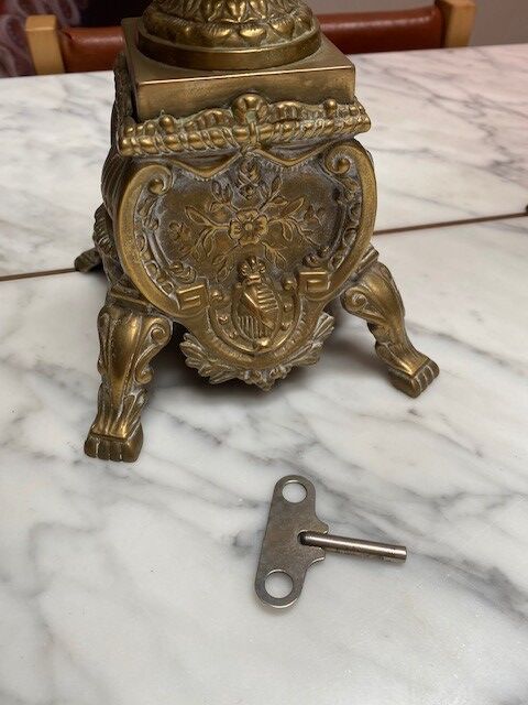 Fireplace trim clock and adornment of antique bronze candelabra