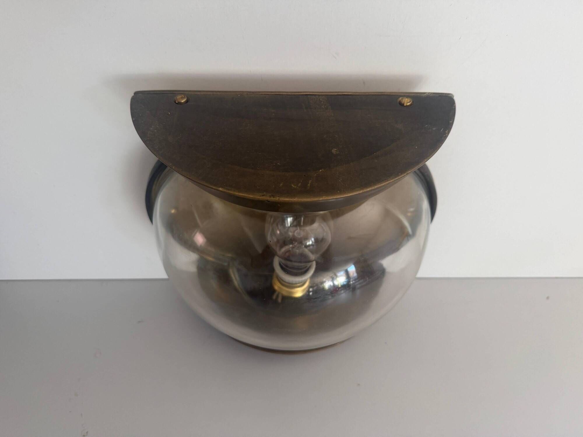 Pair of bronze and glass wall lights from the mid-century, 1960, Italy.