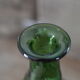 Dented green bottle